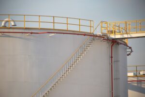 large Industrial tanks for petrol and oil with blue sky.Fuel tanks at the tank farm. metal stairs on