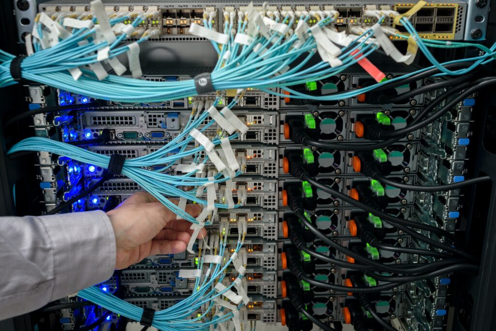 Man data center technician performing server maintenance